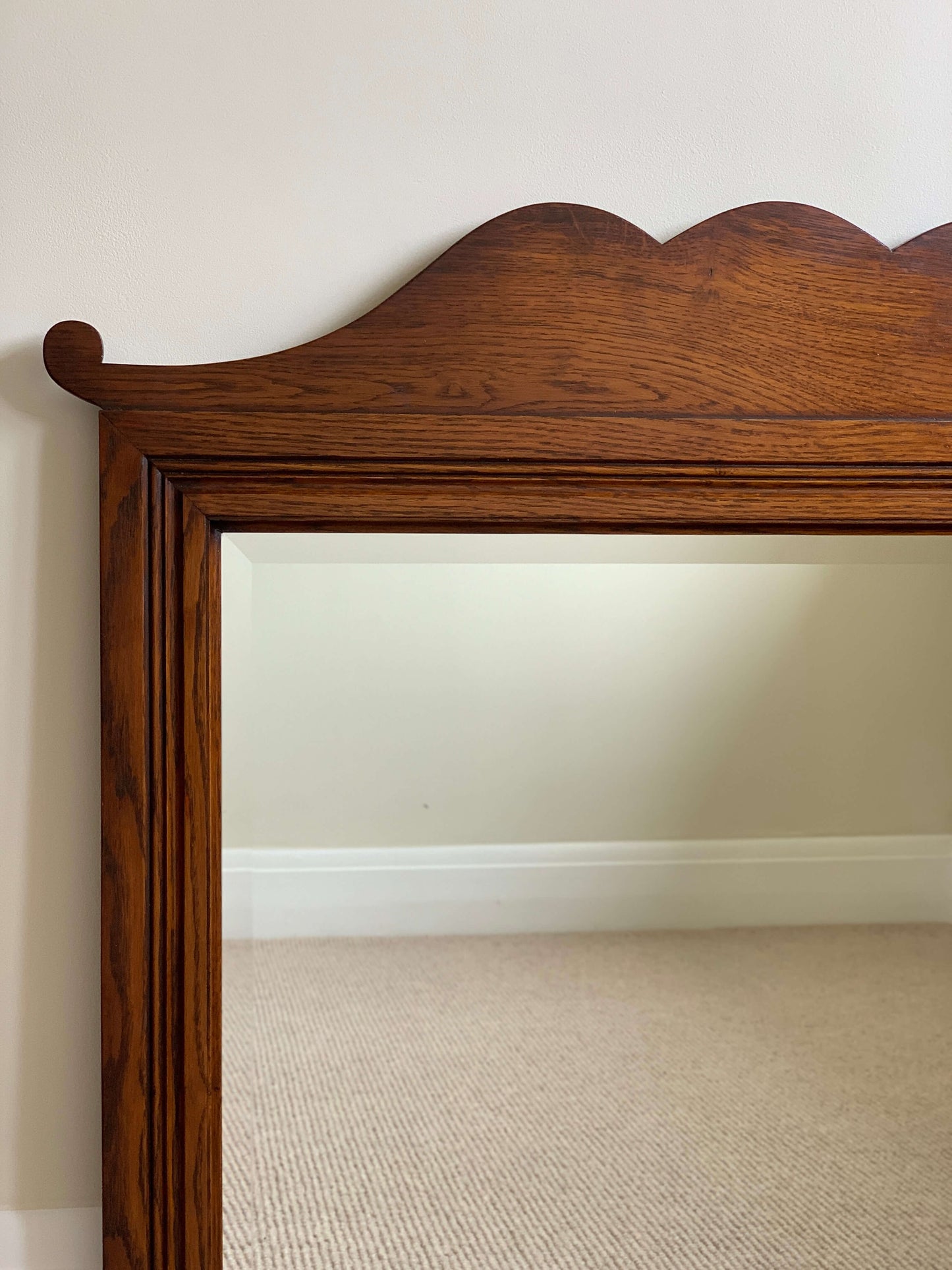 Antique oak framed bevelled mirror with scallop detail