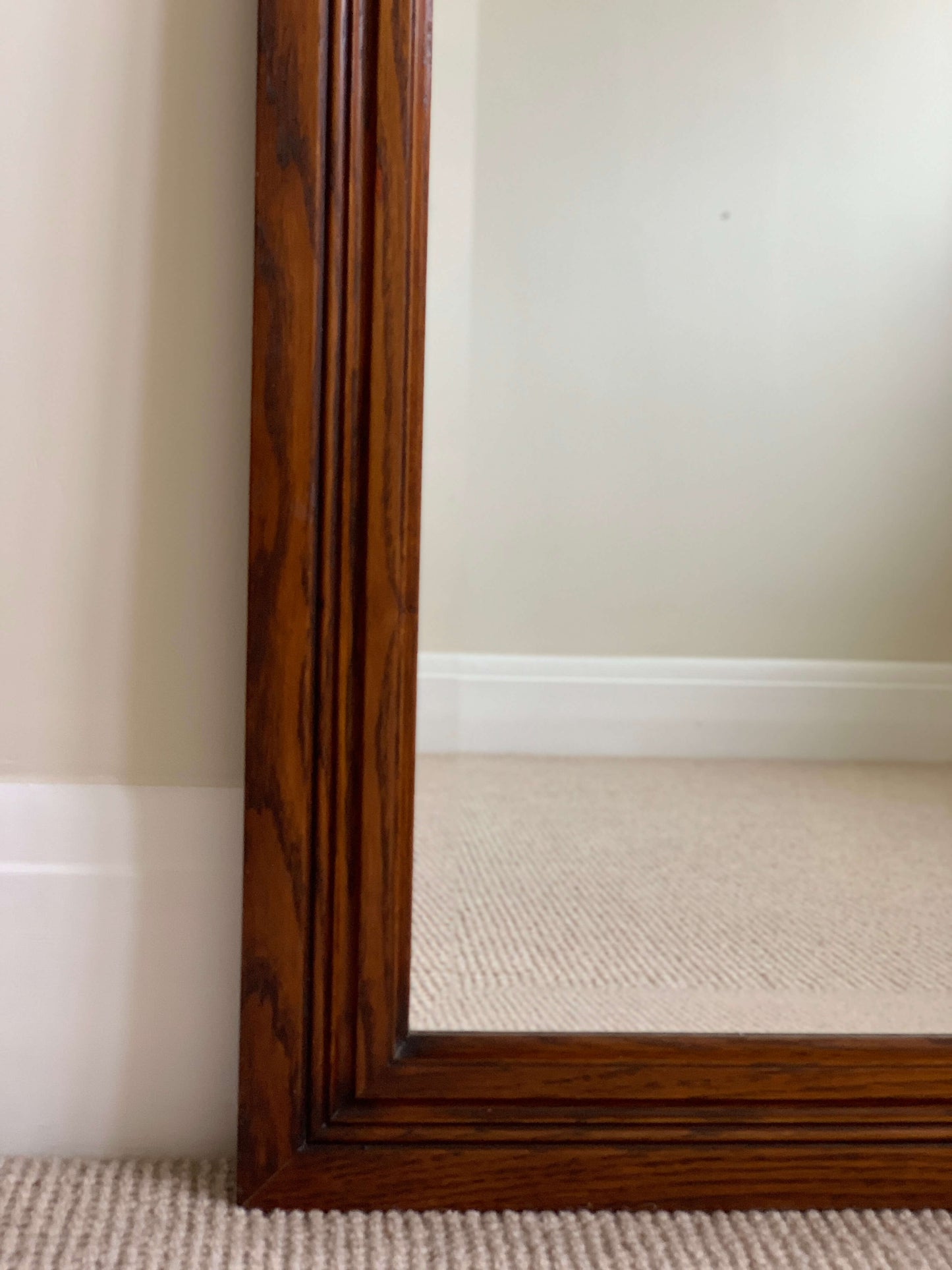 Antique oak framed bevelled mirror with scallop detail