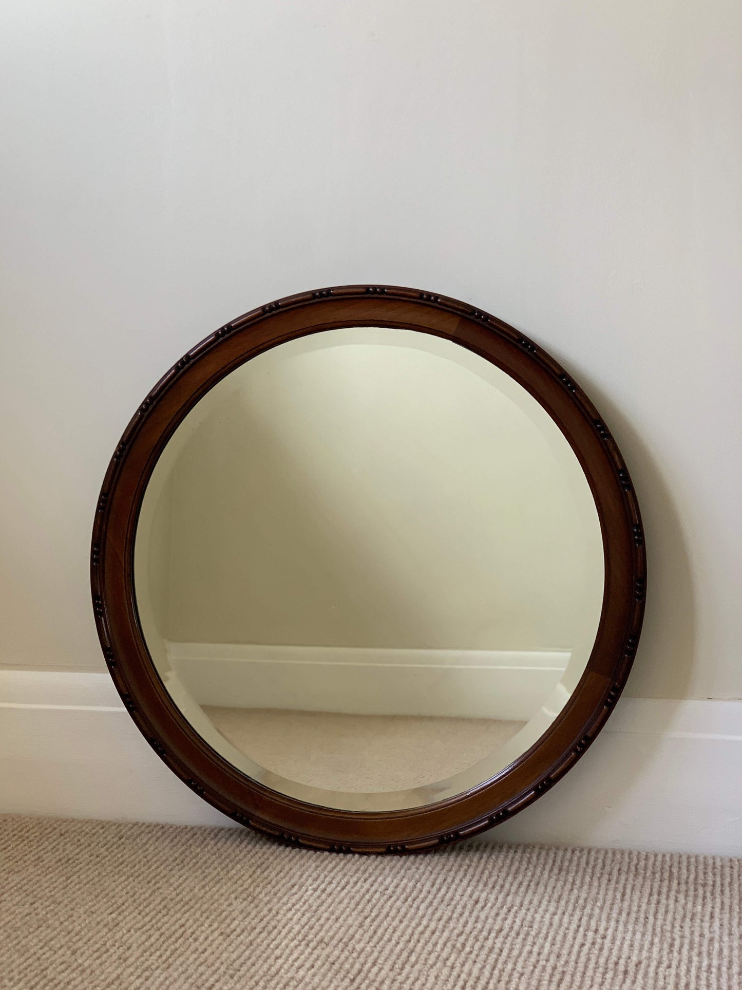 Antique circular bevelled mirror with beaded frame