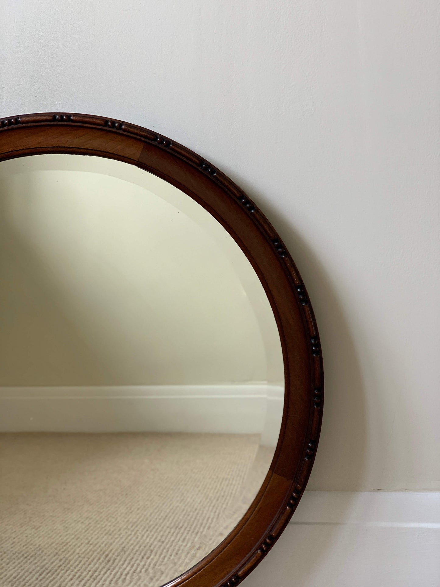 Antique circular bevelled mirror with beaded frame