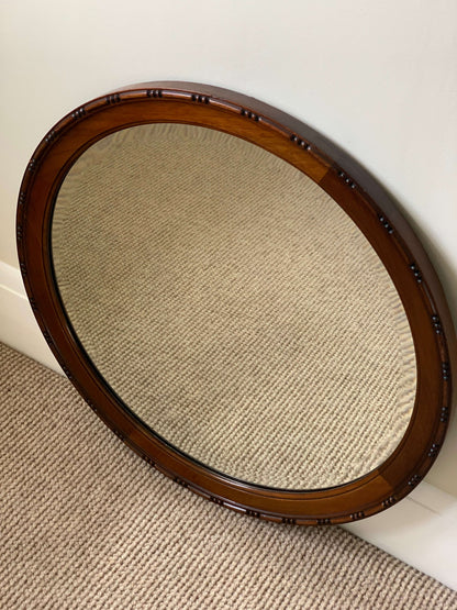 Antique circular bevelled mirror with beaded frame