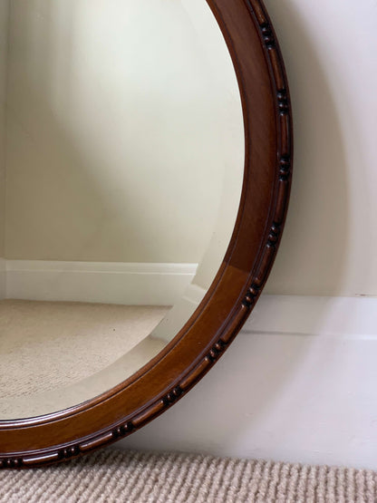 Antique circular bevelled mirror with beaded frame