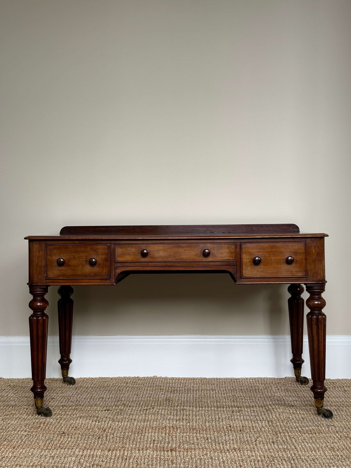 Victorian writing desk on brass castors