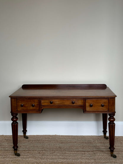 Victorian writing desk on brass castors