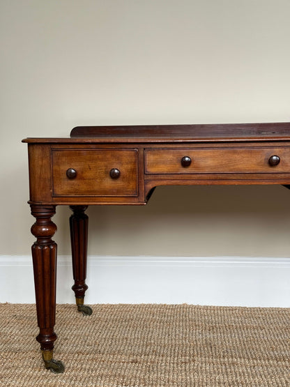 Victorian writing desk on brass castors