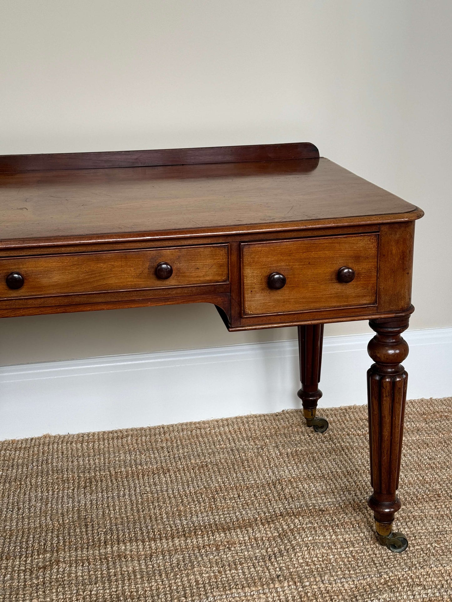 Victorian writing desk on brass castors