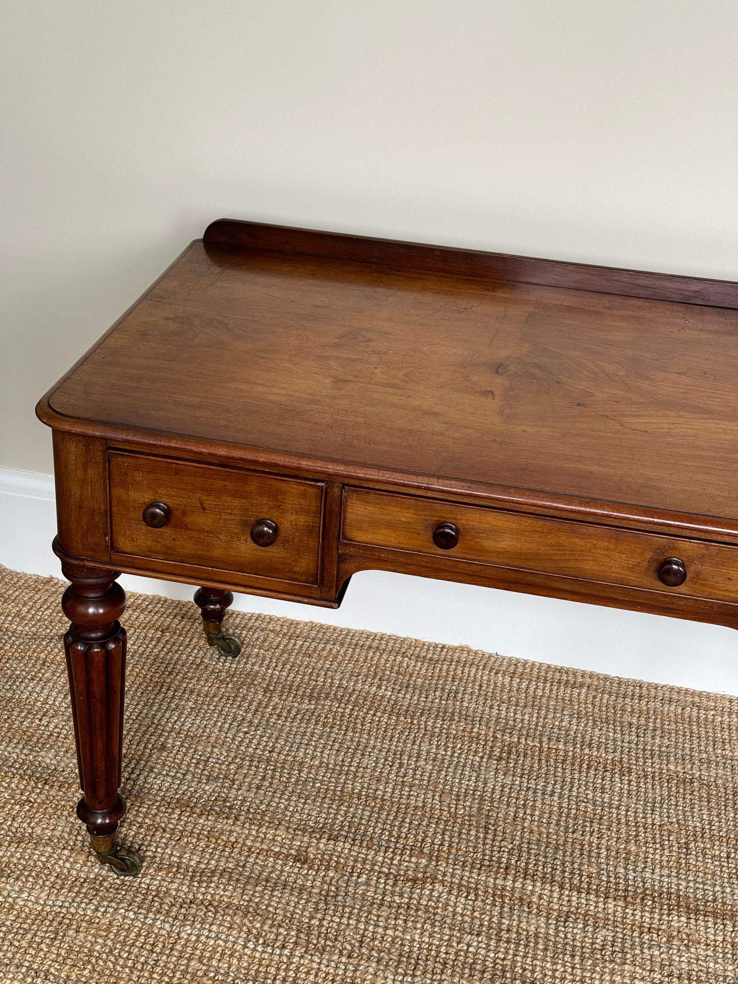 Victorian writing desk on brass castors