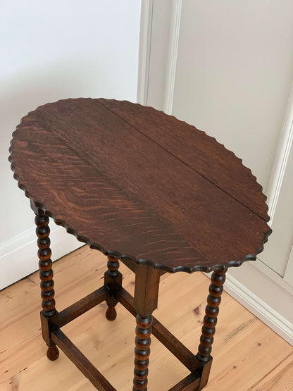 Antique oak table with scalloped edges and bobbin legs