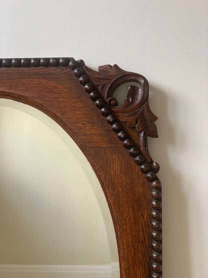 Antique bevelled mirror with carved corners