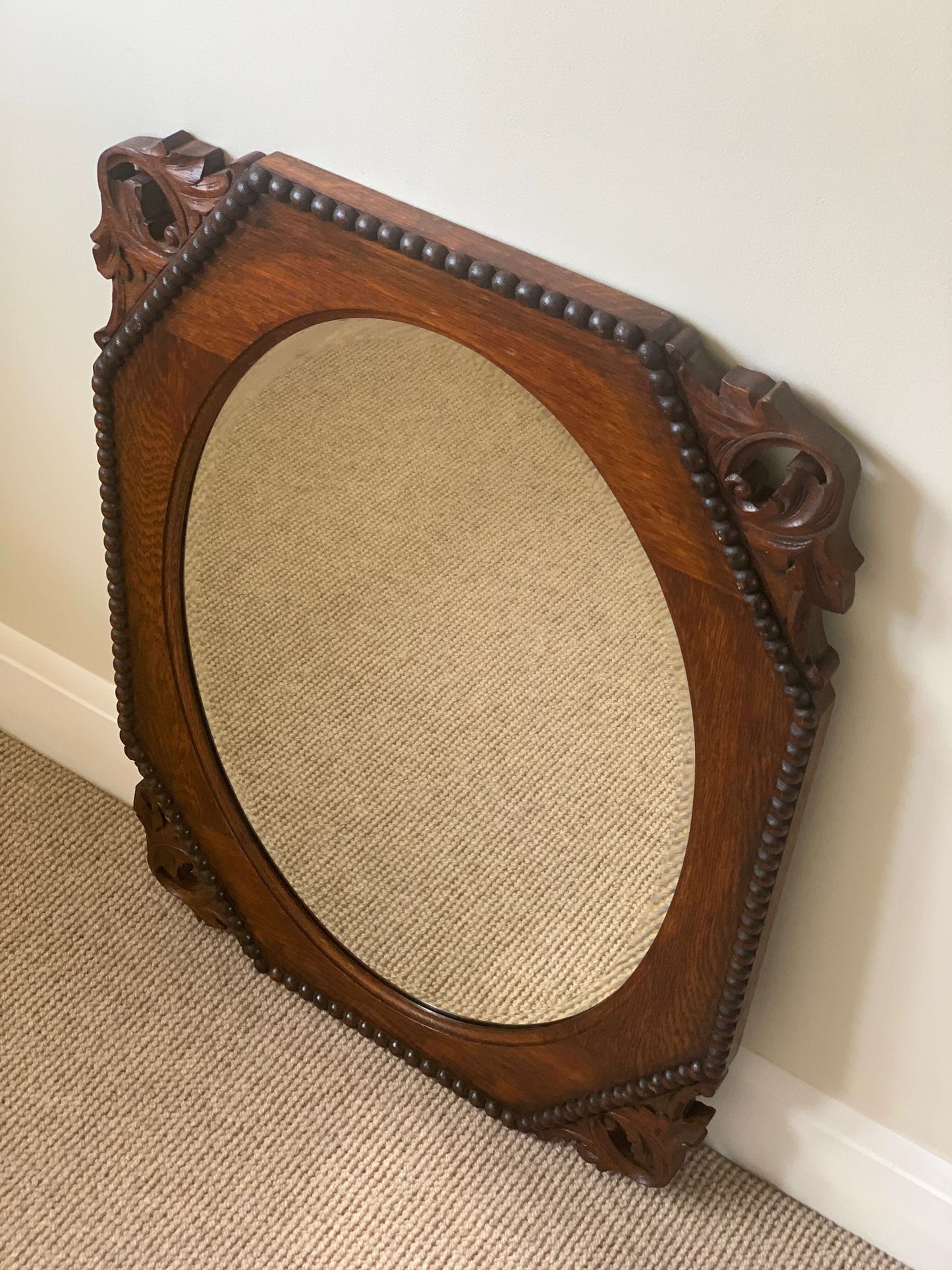 Antique bevelled mirror with carved corners