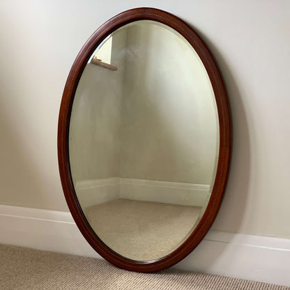 Antique oval mirror with marquetry detail