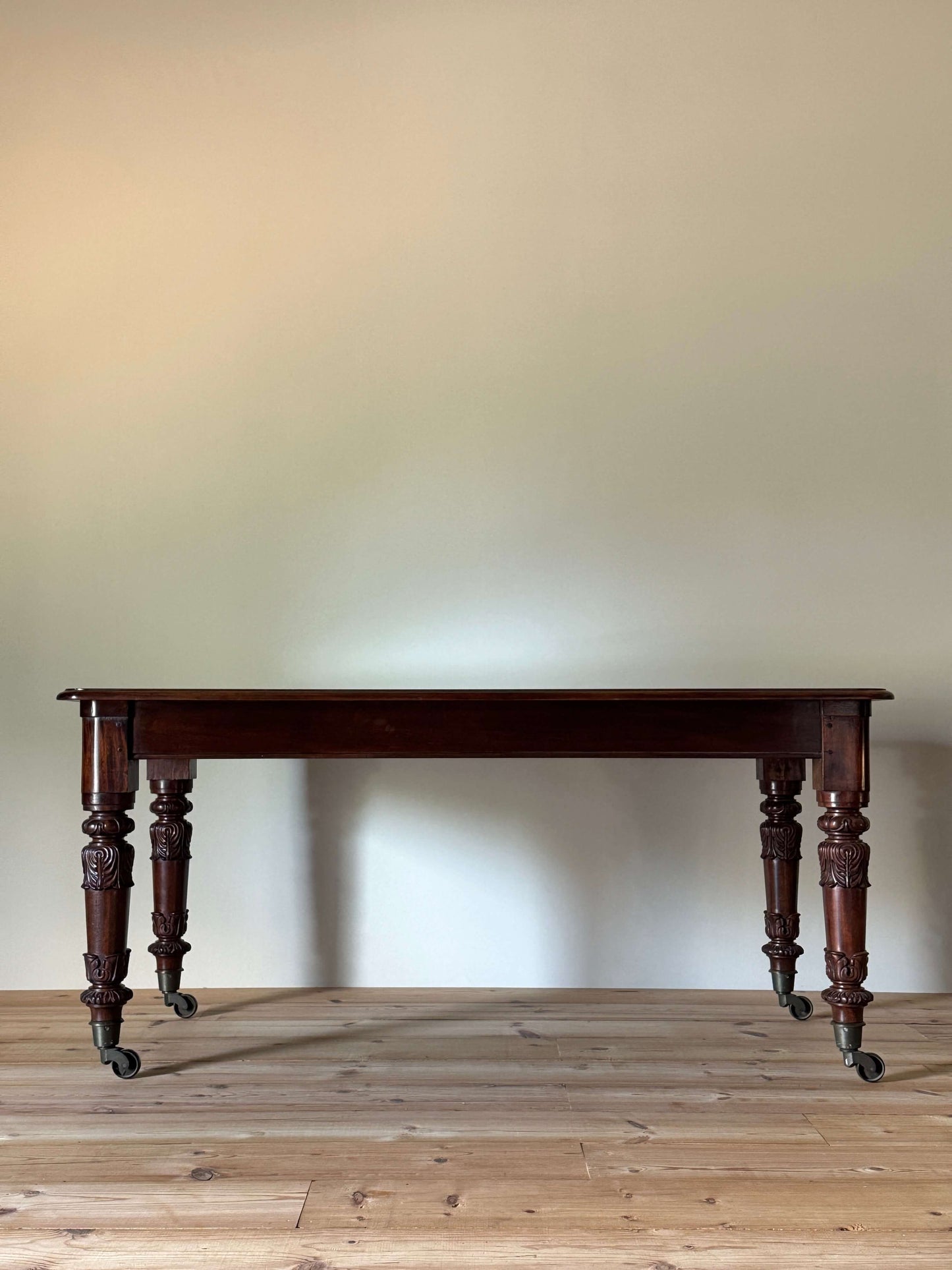 William IV mahogany dining table on brass castors