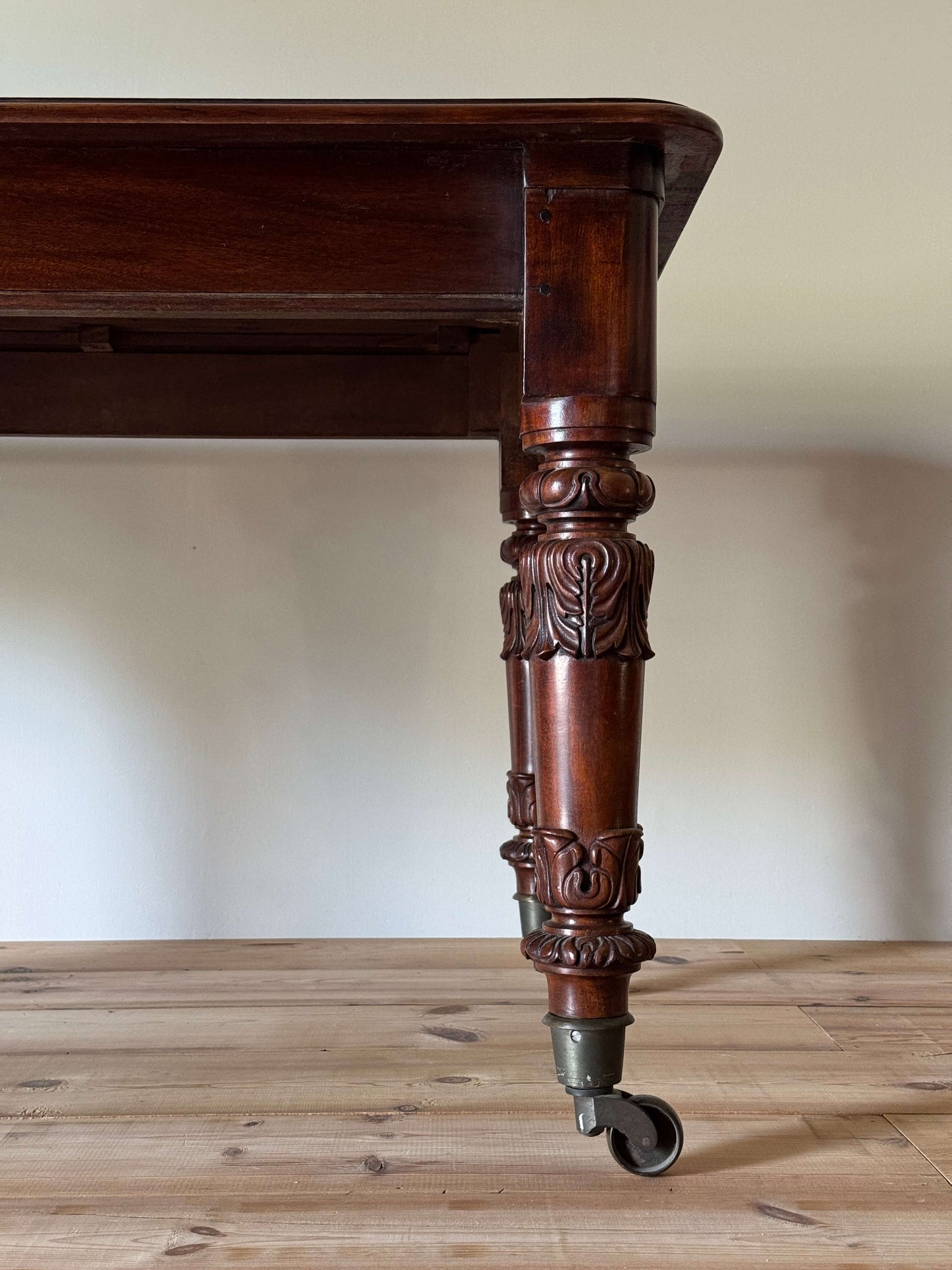William IV mahogany dining table on brass castors