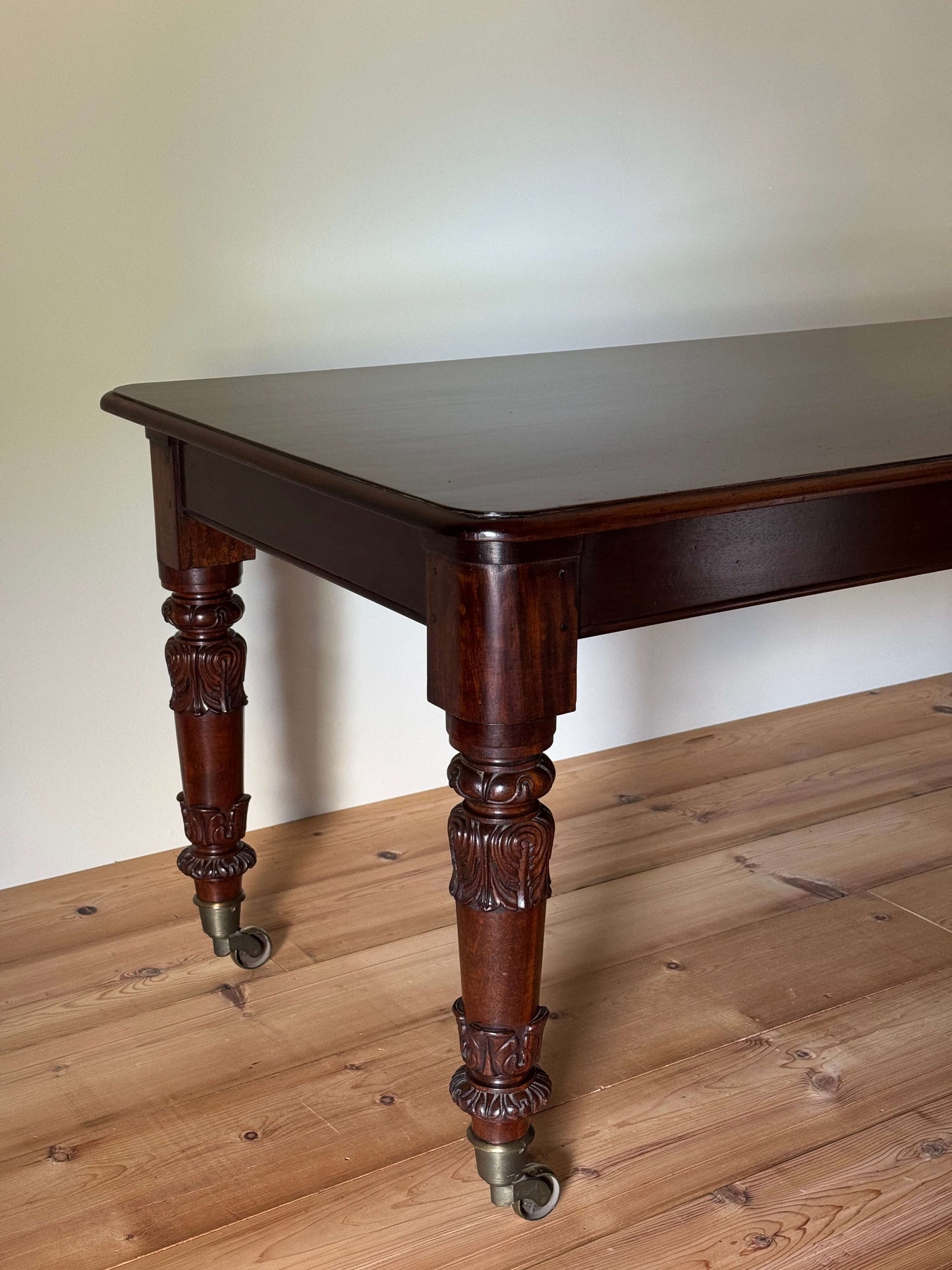 William IV mahogany dining table on brass castors