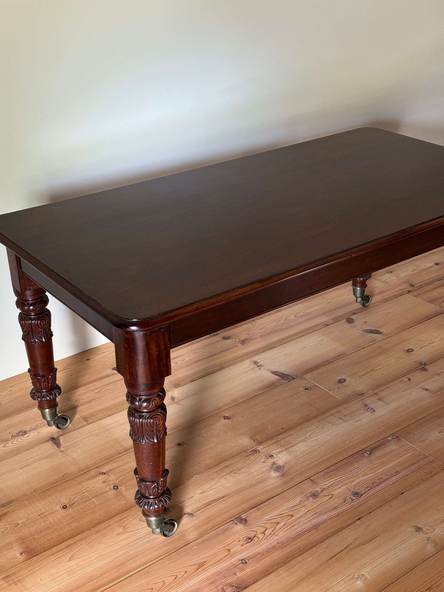 William IV mahogany dining table on brass castors