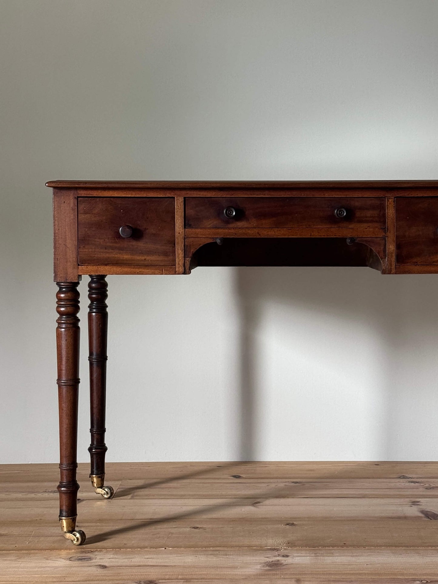Regency mahogany desk on brass castors