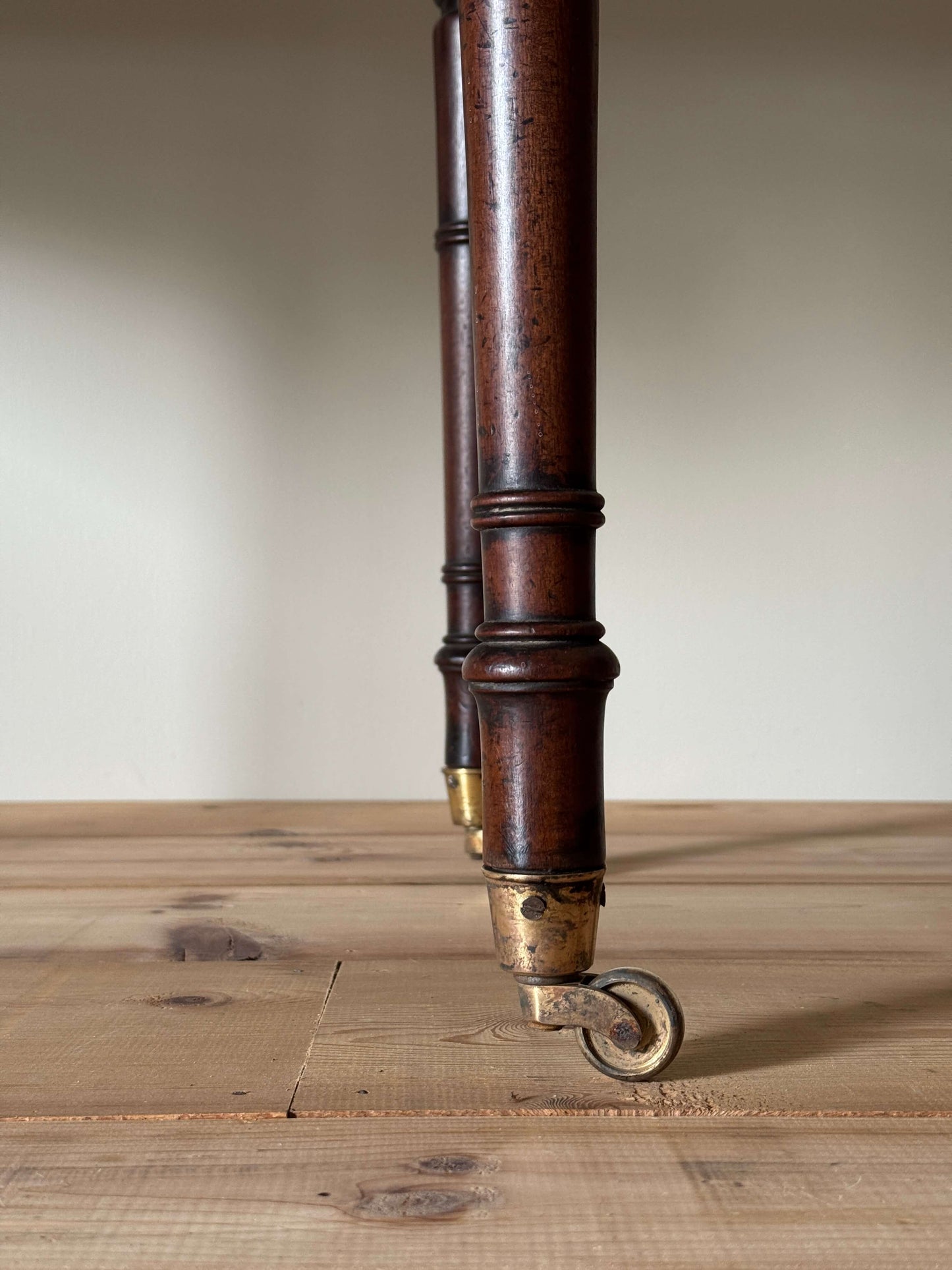 Regency mahogany desk on brass castors