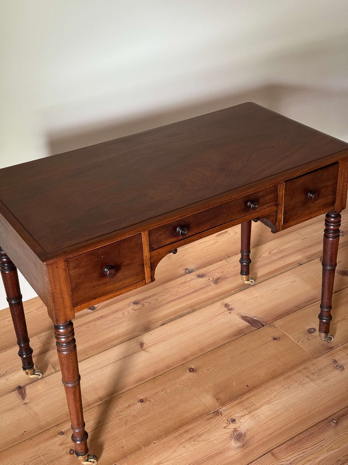 Regency mahogany desk on brass castors