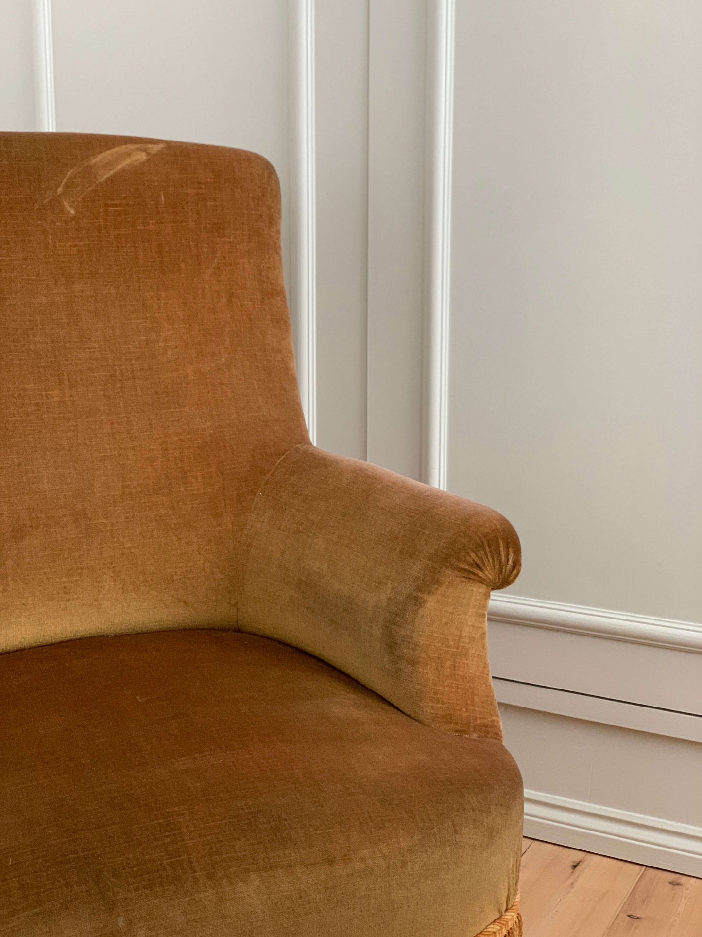 French antique yellow armchair with tasseled skirt