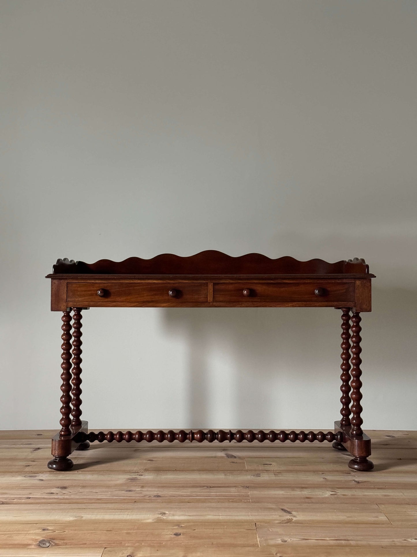 Antique bobbin mahogany console with scalloped gallery