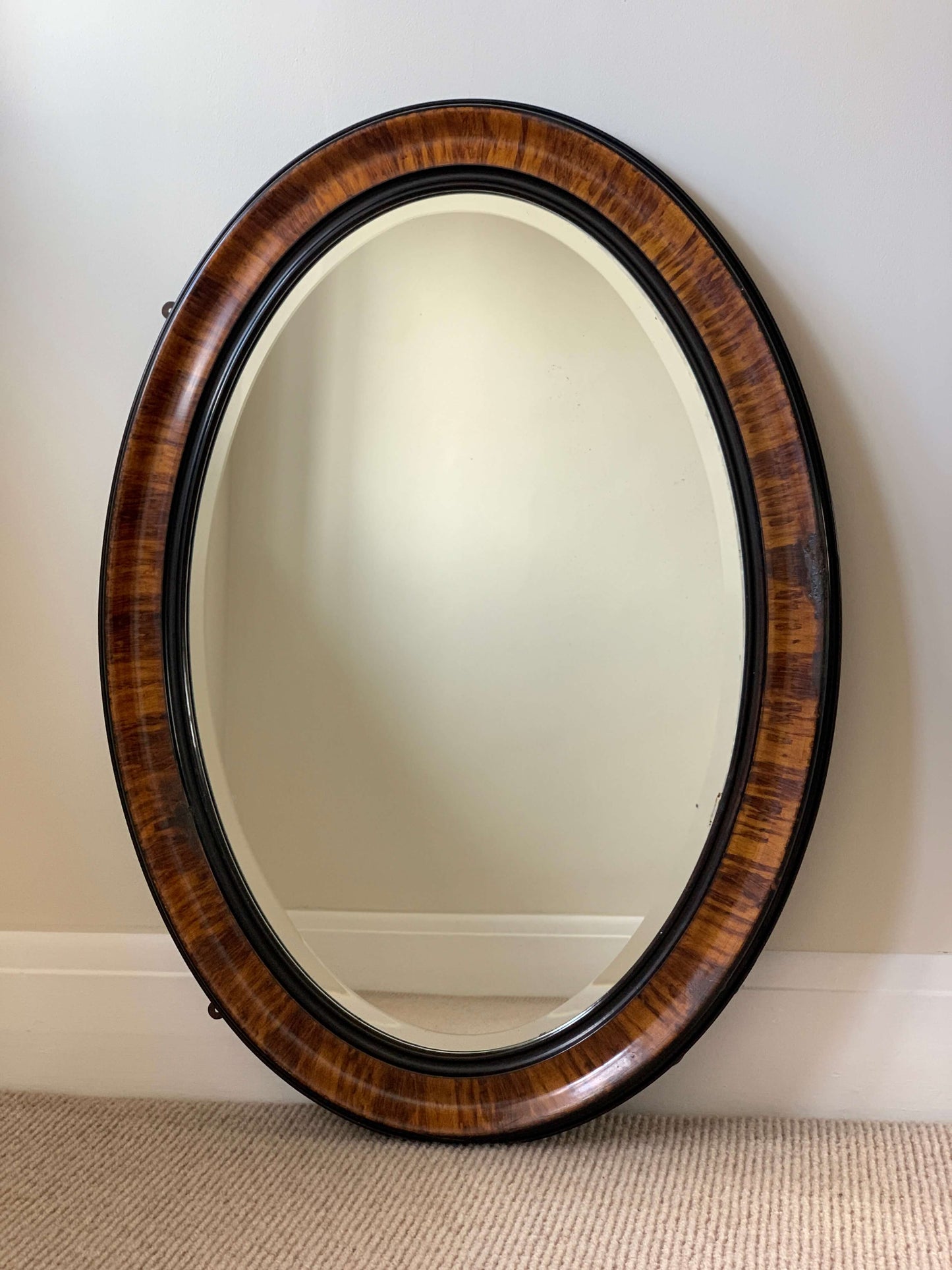 Edwardian oval veneered bevelled mirror