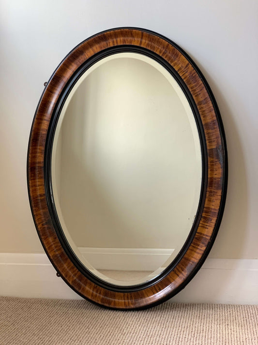 Edwardian oval veneered bevelled mirror