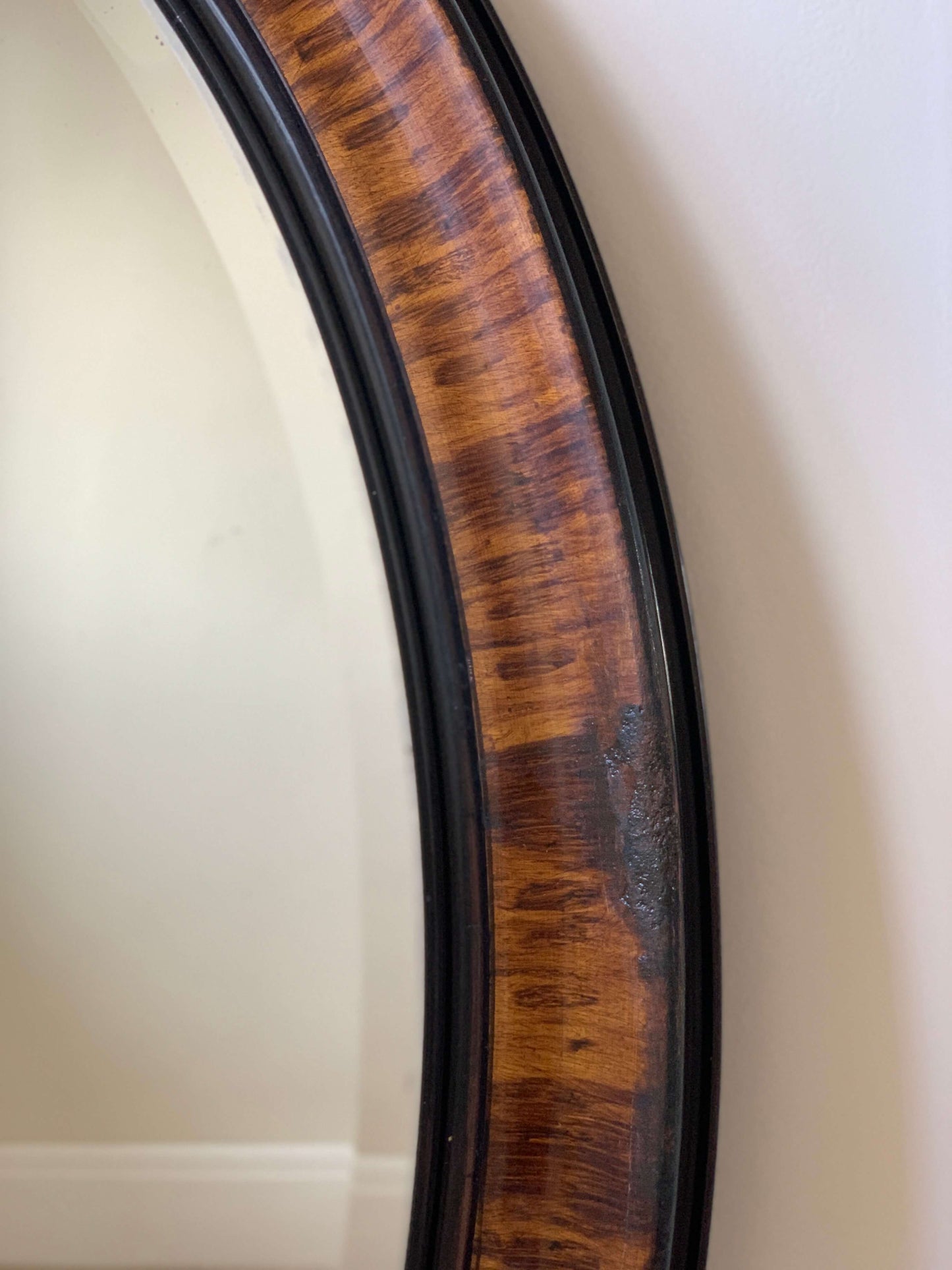 Edwardian oval veneered bevelled mirror