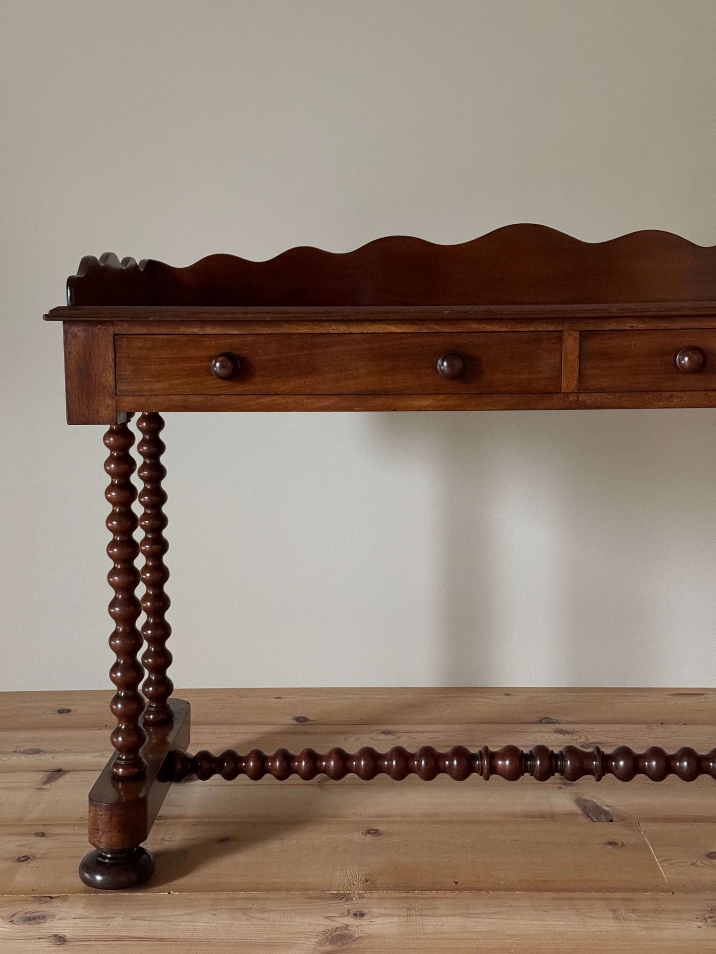 Antique bobbin mahogany console with scalloped gallery