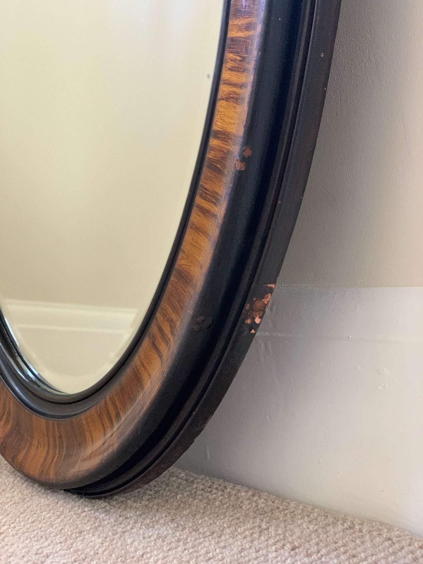 Edwardian oval veneered bevelled mirror