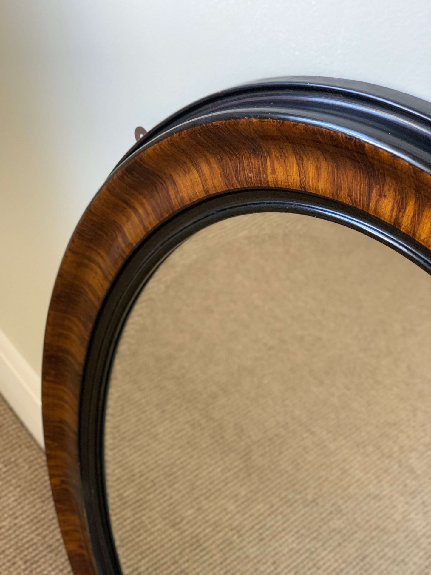 Edwardian oval veneered bevelled mirror