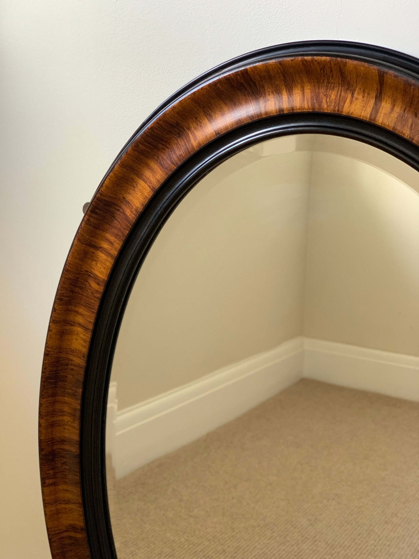 Edwardian oval veneered bevelled mirror