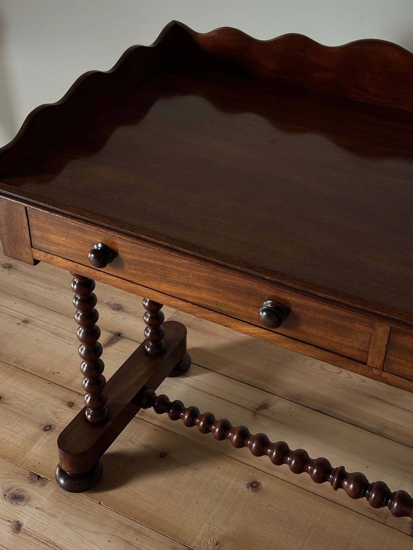 Antique bobbin mahogany console with scalloped gallery