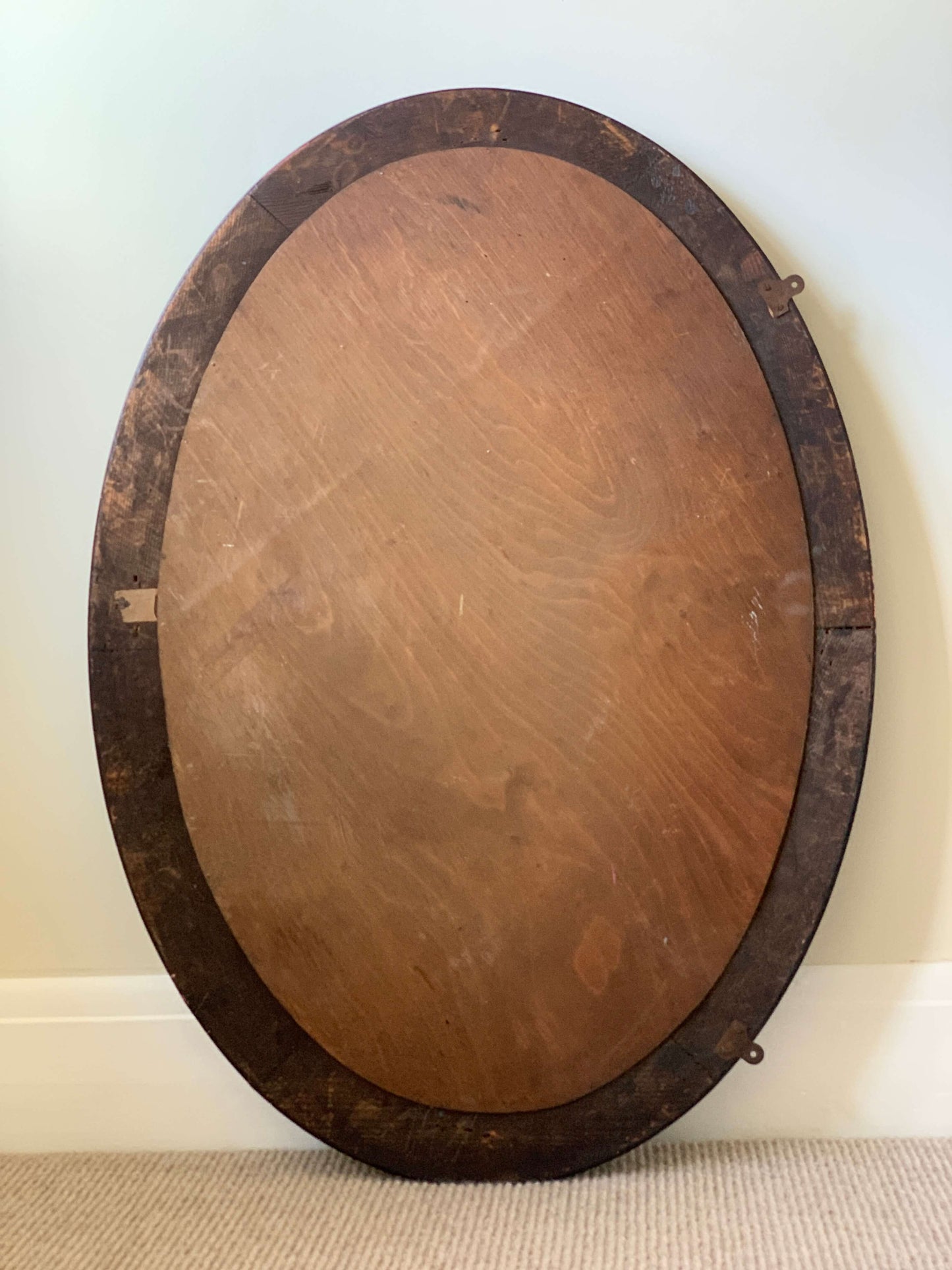 Edwardian oval veneered bevelled mirror