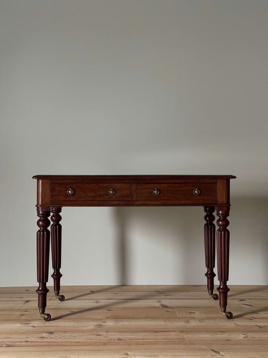 Regency mahogany writing desk on fluted legs and brass casters