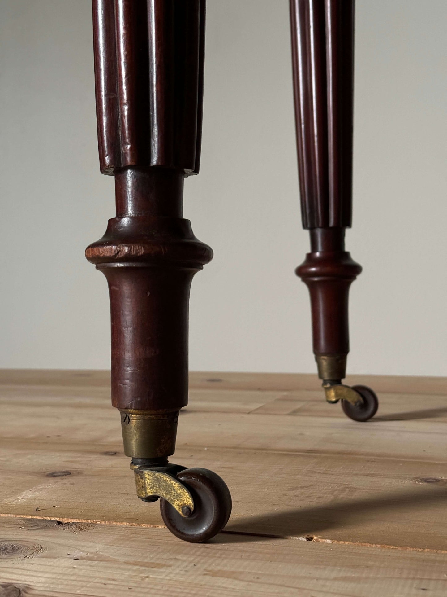 Regency mahogany writing desk on fluted legs and brass casters