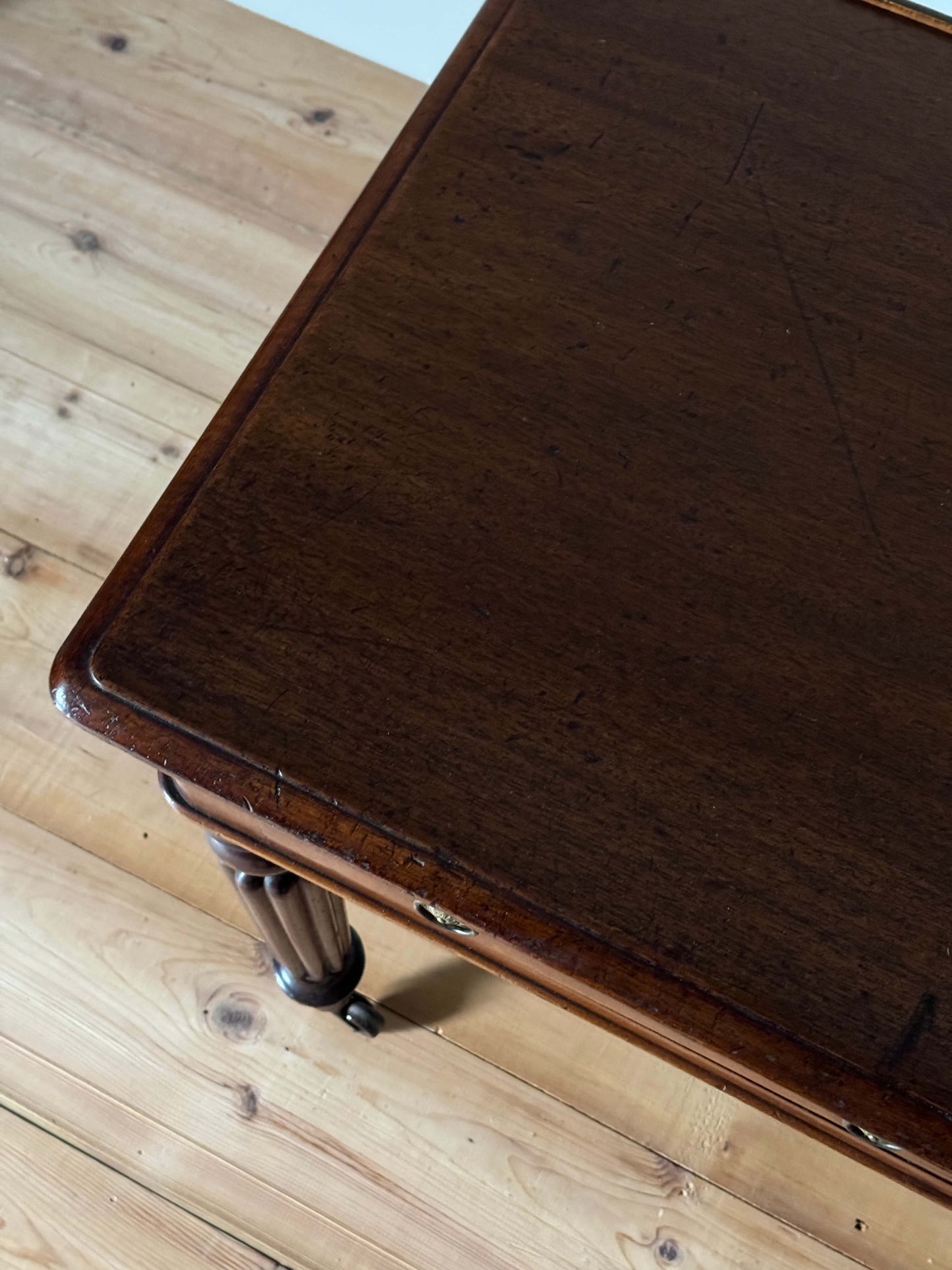 Regency mahogany writing desk on fluted legs and brass casters