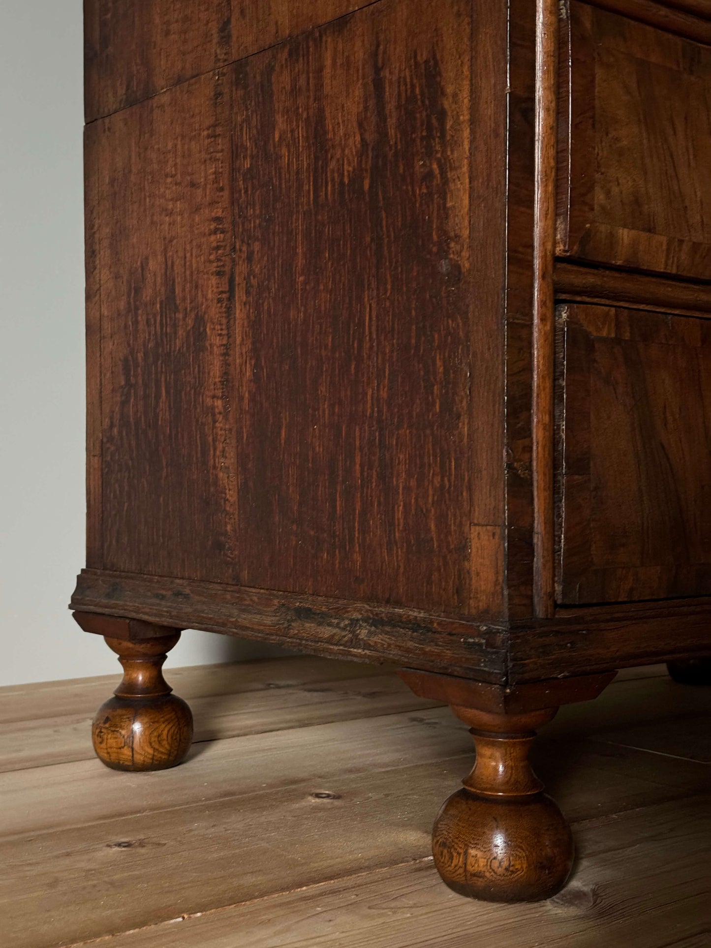 Queen Anne walnut chest of drawers raised on bun feet