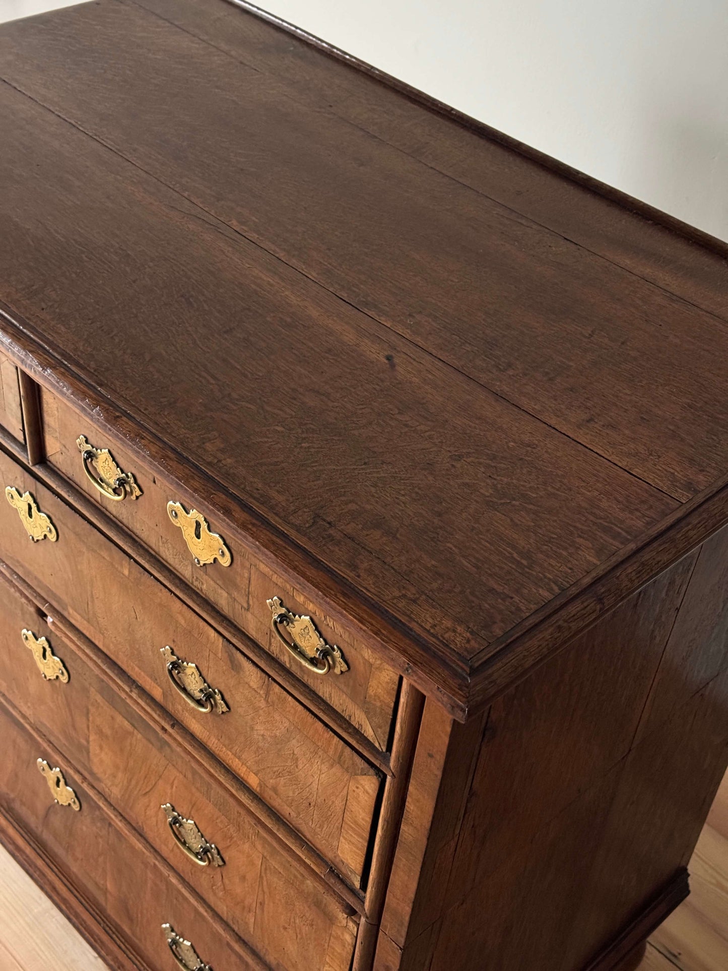 Queen Anne walnut chest of drawers raised on bun feet