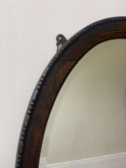 Antique dark oak bobbin detailed oval bevelled mirror