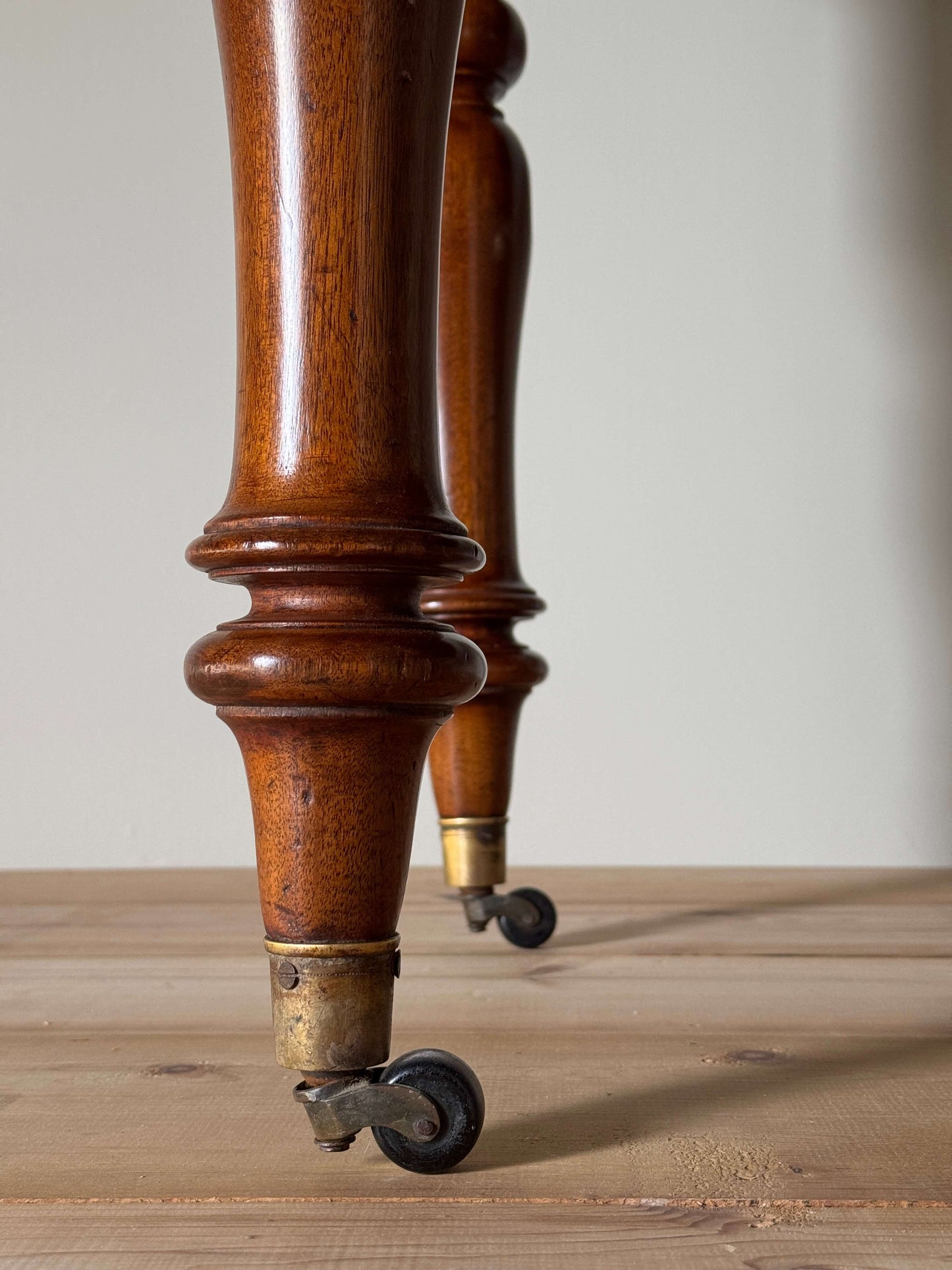 Antique Victorian mahogany writing desk on brass casters