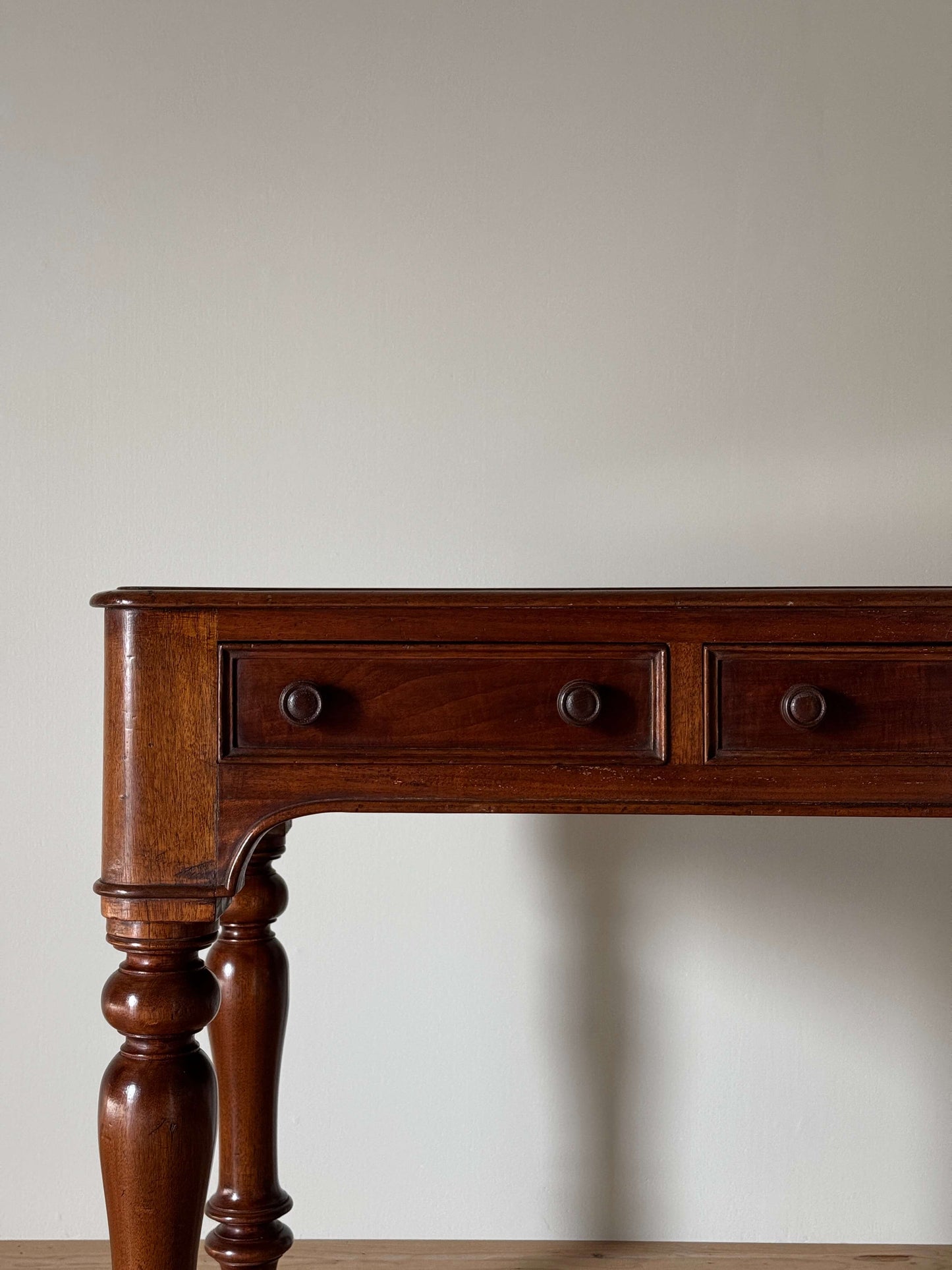 Antique Victorian mahogany writing desk on brass casters