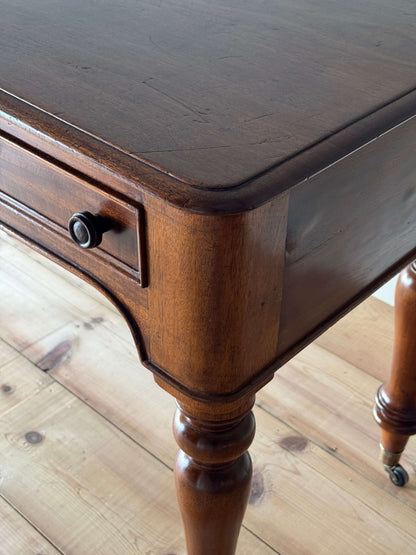 Antique Victorian mahogany writing desk on brass casters