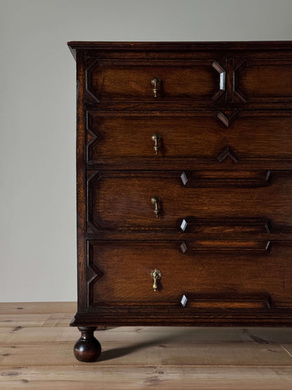 Antique Jacobean revival oak chest of drawers on bun feet