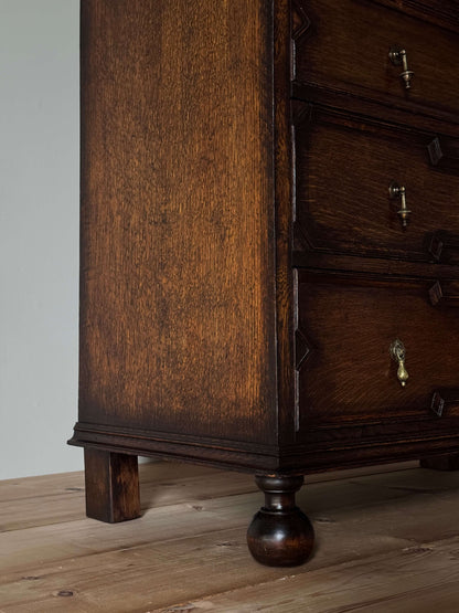 Antique Jacobean revival oak chest of drawers on bun feet