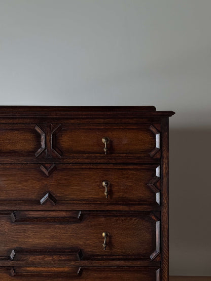 Antique Jacobean revival oak chest of drawers on bun feet