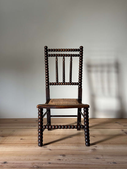 A Victorian bobbin chair with cane seat