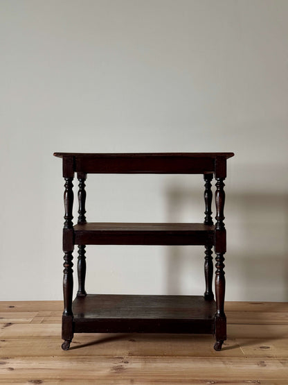 Edwardian three-tiered table on casters