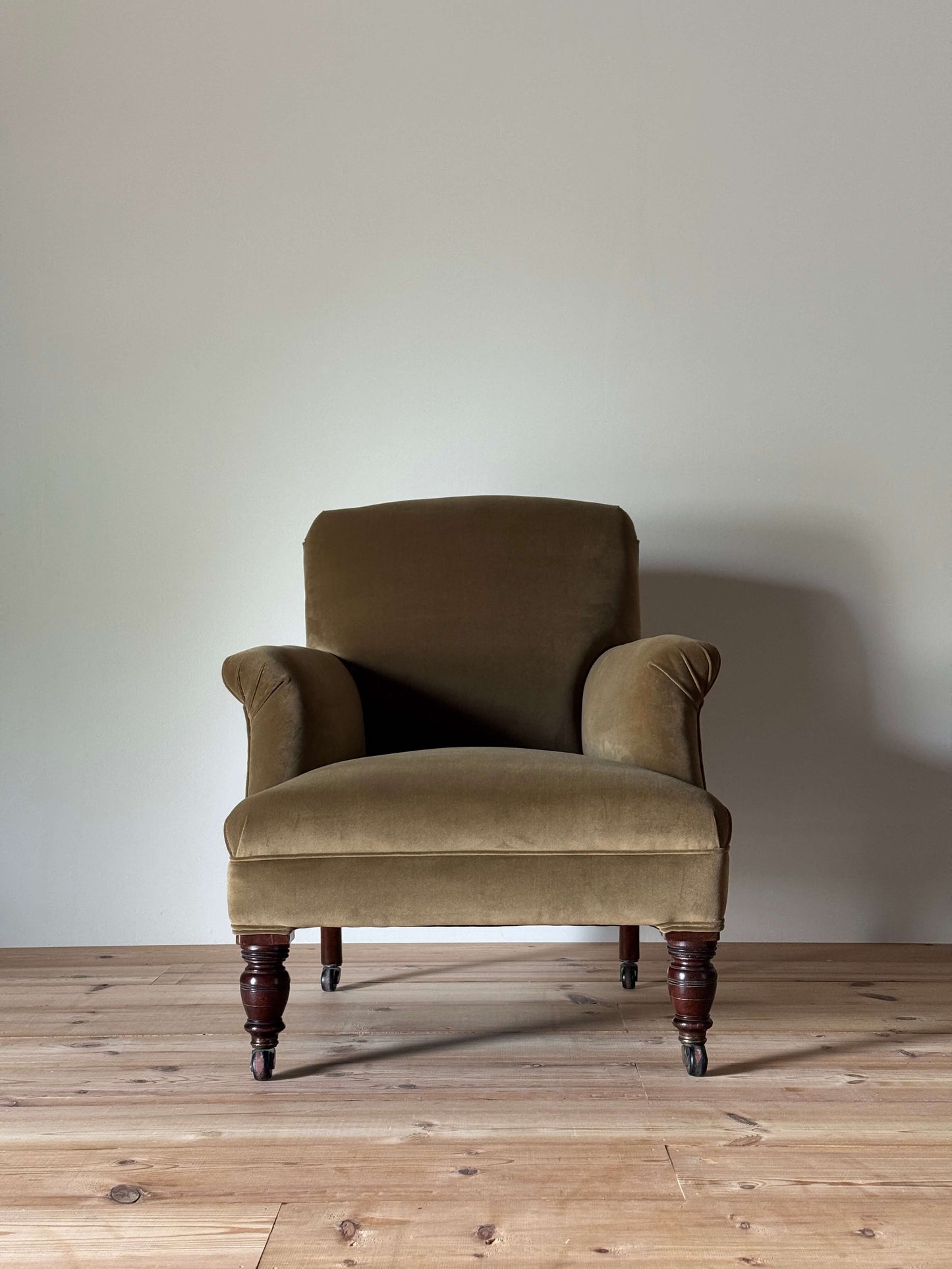Antique Victorian upholstered armchair on castors
