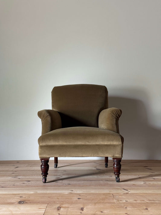 Antique Victorian upholstered armchair on castors