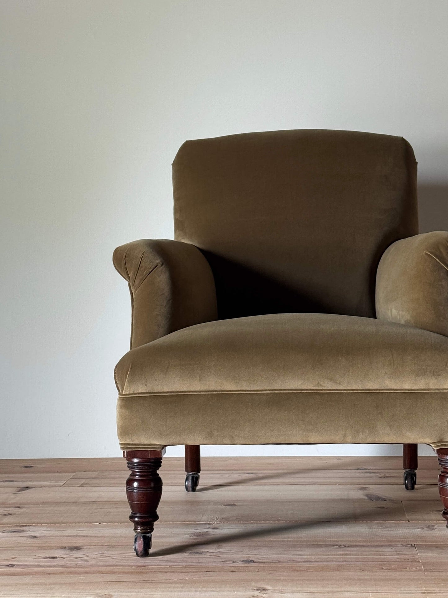 Antique Victorian upholstered armchair on castors